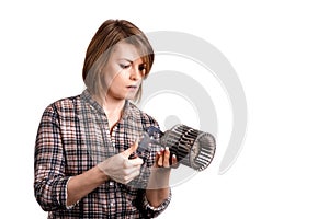 The girl mechanic with a caliper measures a car detail