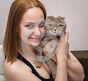 Girl in a medical mask with a cat in her arms