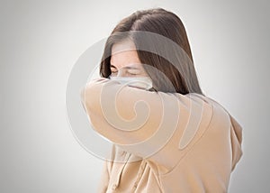 The girl in the medical mask coughs. Close up. Isolated on a grey background