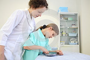 Girl and medical worker looking at the contents of