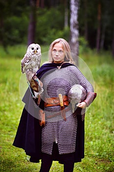 Girl in medieval armor, holding an owl