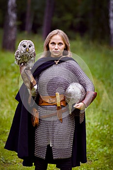 Girl in medieval armor, holding an owl