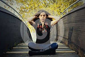 Girl Meditating on Bridge