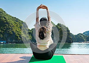 Girl meditating on a cruise boat