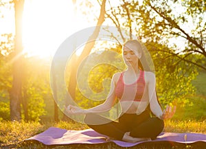 The girl is meditating in the morning.