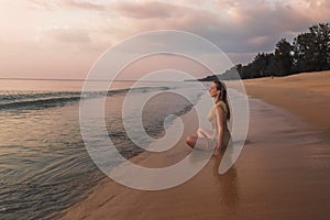 A girl meditating on the ocean shore
