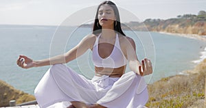 Girl meditating on shoreline