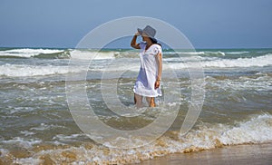 Girl on the Mediterranean coast. Beach of La Mata in Costa Blanca, Spain
