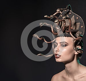 Girl Medusa headdress of gold color on a black background