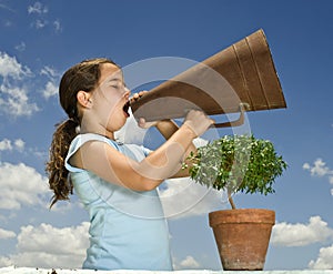 Girl with megaphone and small tree