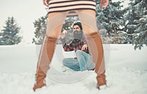 girl and man snowball fight in snowy forest. Christmas couple of happy man and woman. Couple in love in winter