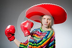 The girl in mexican vivid poncho and box gloves