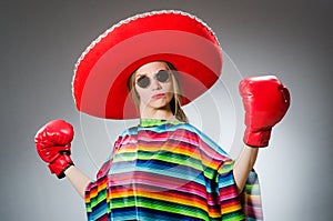 Girl in mexican vivid poncho and box gloves