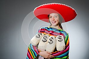 Girl in mexican vivid poncho holding money bags