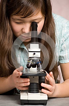 Girl with microscope.