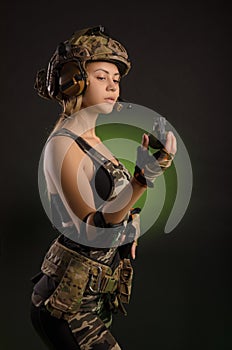 Girl in military uniform and helmet holding a grenade