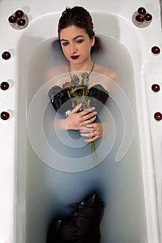 Girl milk water bath red roses candles