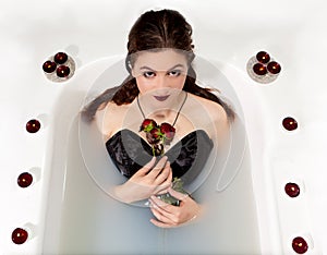 Girl milk water bath red roses candles