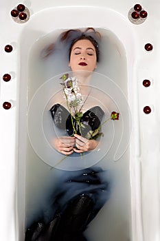 Girl milk water bath red roses candles