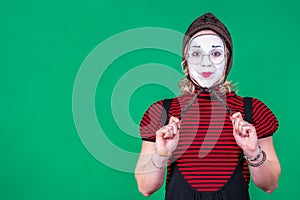 Girl mime posing and grimacing in photo studio