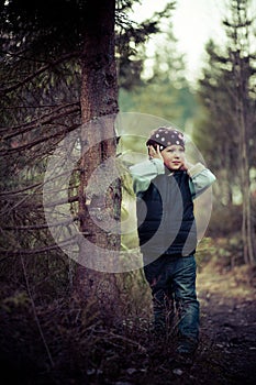 Girl misses the tree in a waistcoat in the woods