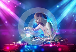 girl mixing music with powerful light effects