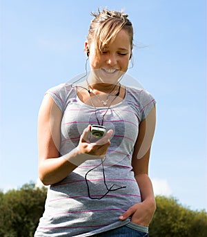 Girl, mobile phone and earphones
