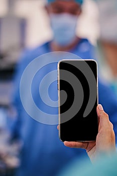 girl with mobile phone in surgery room