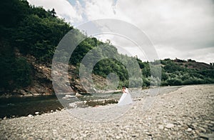 Girl, model, bride on a background of the river and mountains. Beauty portrait