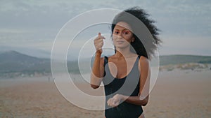 Girl model walking beach pouring sand in hands summer twilight close up.