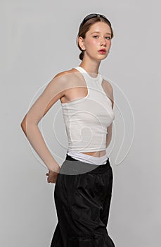 A girl model in a white short top looks