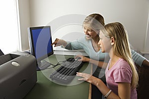 Girl and mom on computer.