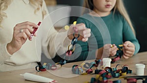 Girl with mom making a Christmas decorations