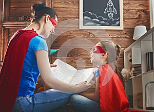 Girl and mom in Superhero costume photo