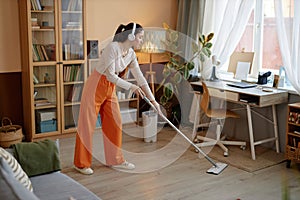 Girl Mopping Floors And Listening To Music