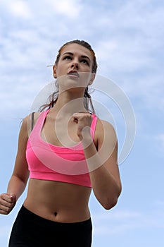 Girl on morning jog on the background of sky