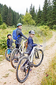 A girl with mother and brother enjoying cycling