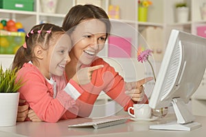 Girl with mother doing shopping online