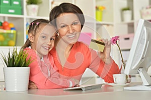 Girl with mother doing shopping online