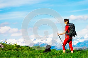 Girl during a mountain hiking trip with her dog