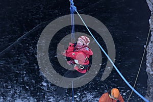 The girl in the mountaineering gear coming down on a rope