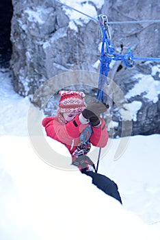 The girl in the mountaineering gear coming down on a rope