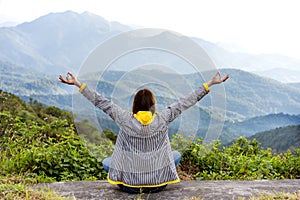 Girl in the mountains, freedom concept, rear view.