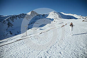 Girl in the mountains in winter. Beautiful winter nature. Snowy mountain peaks.