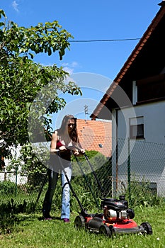 Girl mowing her yard in Germany