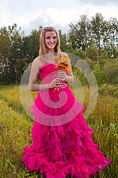 Girl muddy prom dress holding flowers
