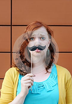 Girl with mustache party accessory