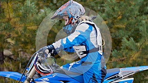 Girl mx biker - motocross racer on dirt bike at sport track