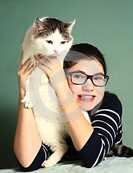 Girl in myopia glasses hug big siberian cat