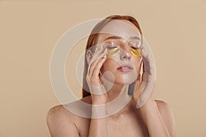 Girl with naked shoulders and undereye patches photo